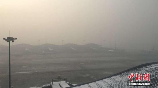 乌鲁木齐国际机场遭大雾侵袭致32趟航班延误或取消。 朱柏霖 摄